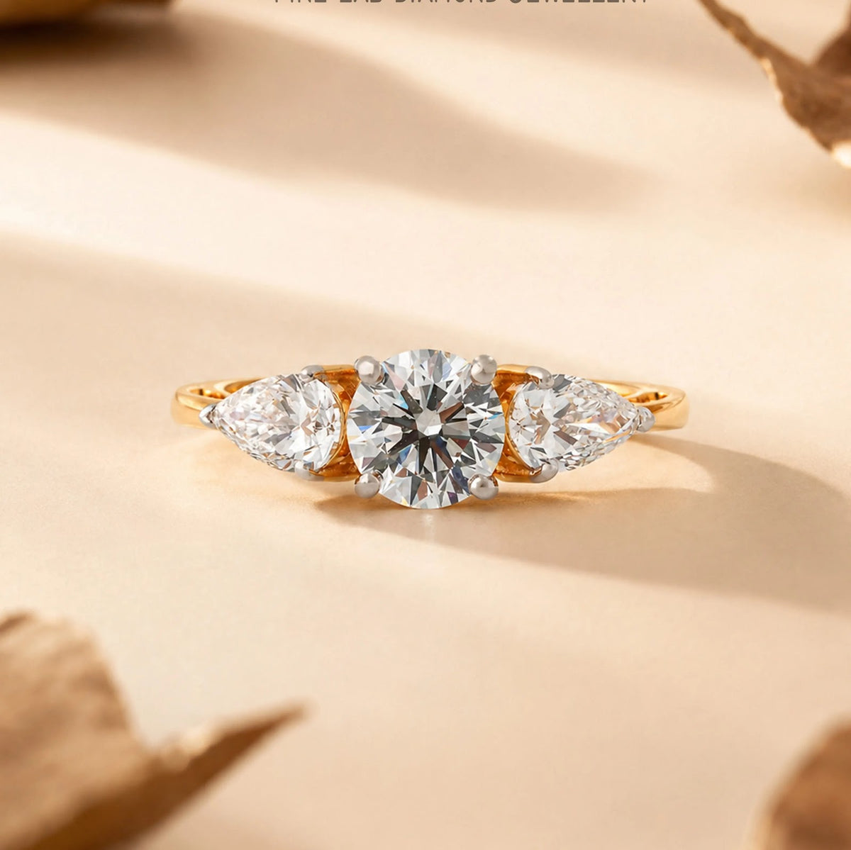 Round and Pear Three-Stone Diamond Ring - front view
