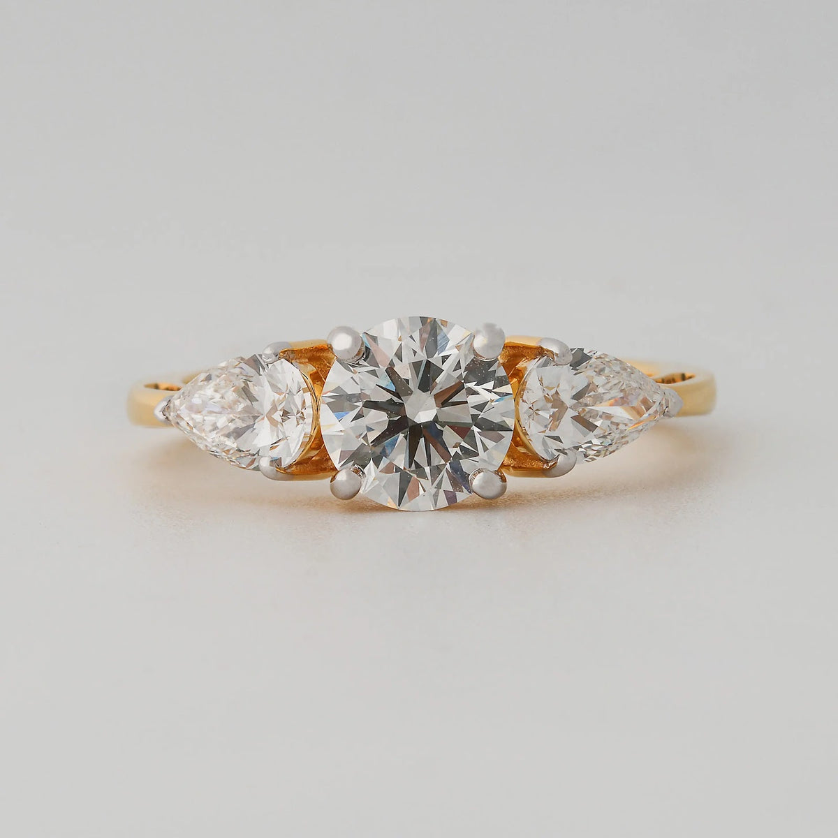 Round and Pear Three-Stone Diamond Ring - angled view